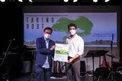 Chairman of BT BAF, Wong Wei Kong (left) receiving the Title Deed for the 2 hectares of virtual real estate from director of business development of HATTENX, Edern Tan.