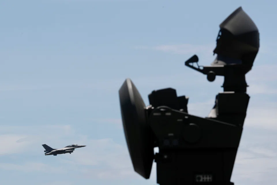 A Taiwan Air Force F-16v flies over a radar installation during an exercise as part of a combat readiness mission inside an airbase in Taiwan on Aug 18, 2022. Tensions over Taiwan have sharply escalated after recent visits by US lawmakers to the island.