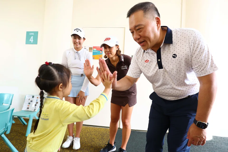 HSBC Singapore CEO Wong Kee Joo meets some children during a visit to local charity SPD, in conjunction with the HSBC Women's World Championship golf tournament at Sentosa.