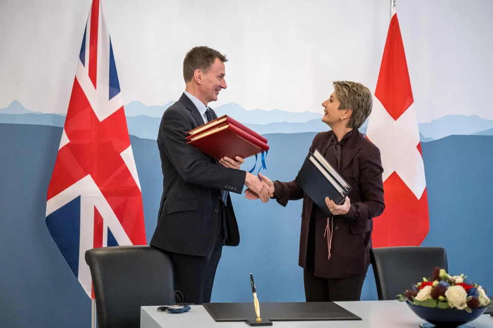 British finance minister Jeremy Hunt (L) travelled to Bern to sign the deal with his Swiss counterpart Karin Keller-Sutter.