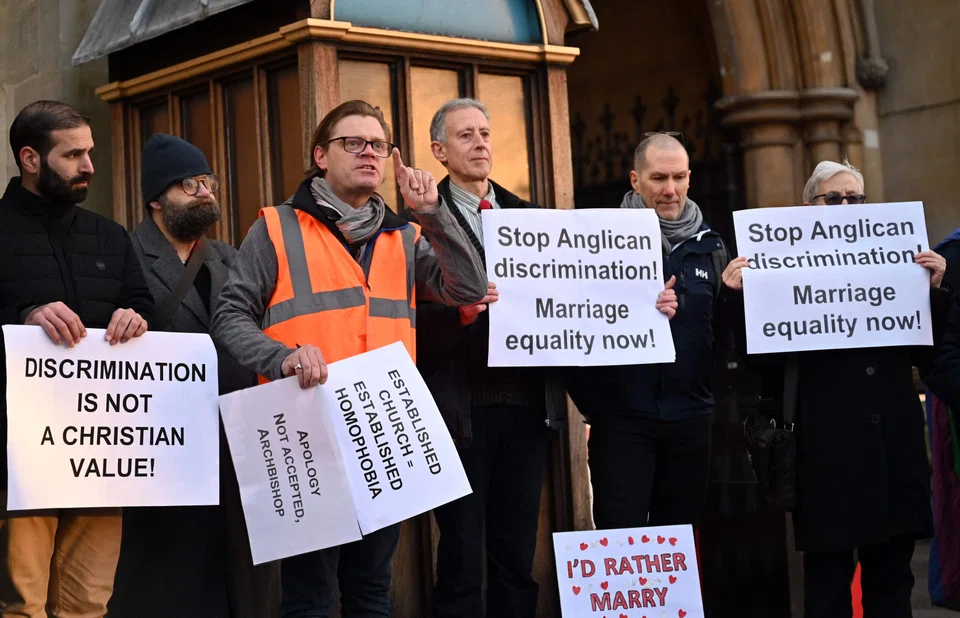 Pro-LGBT+ activists take part in a demonstration outside of Church House, in London, on day three of the Church of England's General Synod. A priest asked about developing more inclusive language for those who wish to speak of God in a “non-gendered way”.