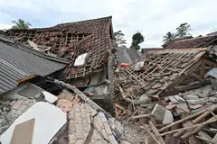 A man (right) sifts through the rubble of a collapsed house in Cugenang, Cianjur on Nov 23, 2022, following a 5.6-magnitude earthquake on Nov 21.