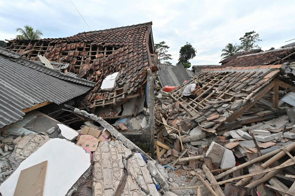 A man (right) sifts through the rubble of a collapsed house in Cugenang, Cianjur on Nov 23, 2022, following a 5.6-magnitude earthquake on Nov 21.