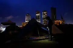 A protester sits in a camp site, after police asked them to leave from a seafront tent camp that became the focal point of months-long nationwide demonstrations, amid Sri Lanka's economic crisis.