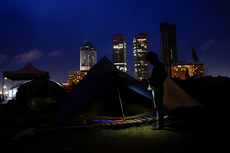 A protester sits in a camp site, after police asked them to leave from a seafront tent camp that became the focal point of months-long nationwide demonstrations, amid Sri Lanka's economic crisis.