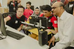 President Tharman Shanmugaratnam (right) at Tuesday's pilot financial literacy workshop by DBS Foundation and SG Enable, where persons with disabilities received guidance from DBS volunteers.