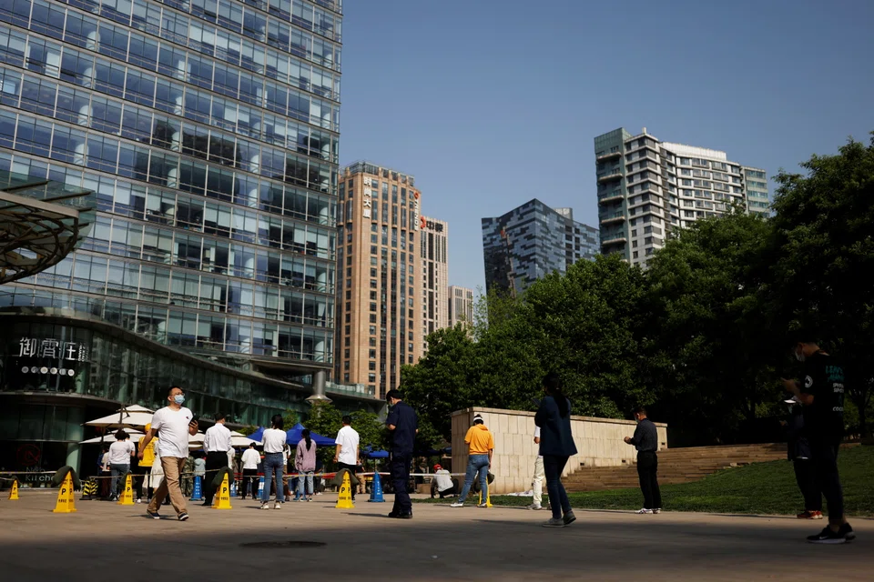 People line up at a Covid-19 testing site at the CBD in Chaoyang district, Beijing on May 5, 2022. 