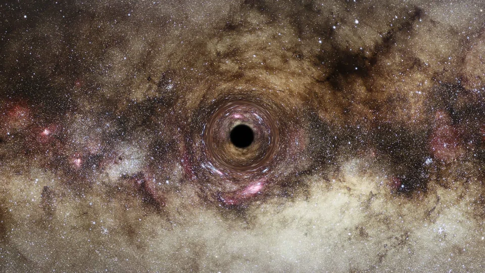 An artist’s impression of a black hole in the Milky Way galaxy, which distorts light passing near it creating a phenomenon known as “gravitational lensing”.  One of the largest black holes ever recorded has been discovered using a new technique that could spot thousands more of the celestial monsters in the coming years, according to astronomers. 