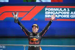 Winner Red Bull Racing's Mexican driver Sergio Perez celebrates on the podium after the Formula One Singapore Grand Prix night race at the Marina Bay Street Circuit in Singapore on October 2, 2022. (Photo by MOHD RASFAN / AFP)