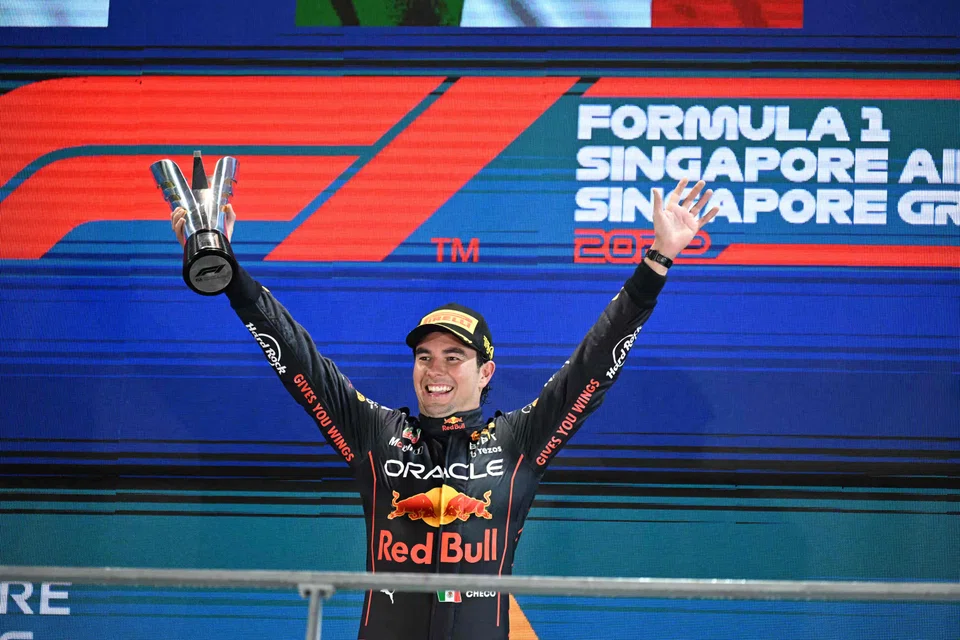Winner Red Bull Racing's Mexican driver Sergio Perez celebrates on the podium after the Formula One Singapore Grand Prix night race at the Marina Bay Street Circuit in Singapore on October 2, 2022. (Photo by MOHD RASFAN / AFP)