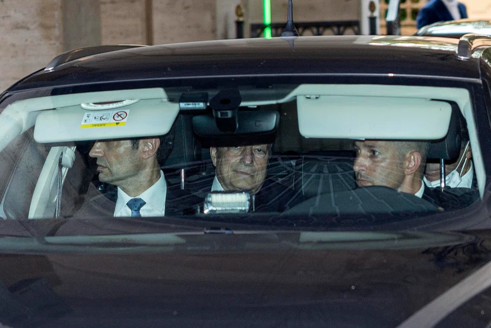 Italian Prime Minister Mario Draghi (centre) leaves the Quirinal Palace after talks with Italy's President Sergio Mattarella in Rome, Italy, July 14, 2022. Mattarella has not accepted Draghi's resignation, inviting him to go to the Chambers to assess the situation.  