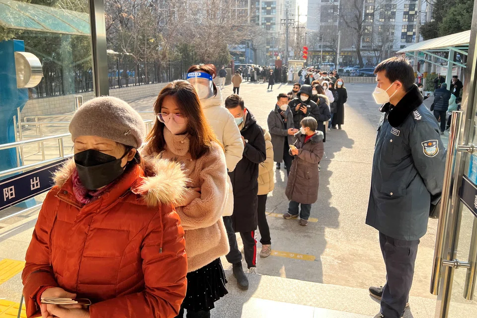 People lining up at a government office to renew their passports after China dropped border controls.
