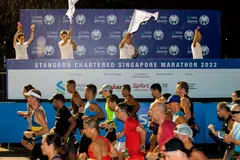 STB's executive director of sports and wellness Ong Ling Lee (far left) flagging off the runners at the 2022 Standard Chartered Singapore Marathon.