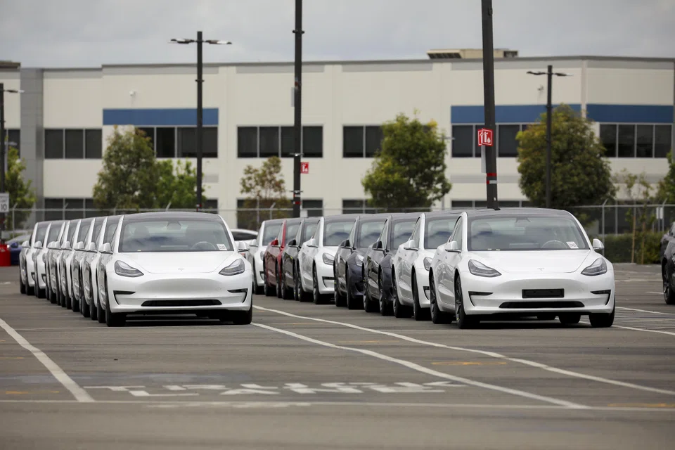 Cars lined up outside the Tesla car manufacturing plant in California. The US purchasing managers' index has stayed below the 50 threshold for eight straight months indicating a contraction in manufacturing. 