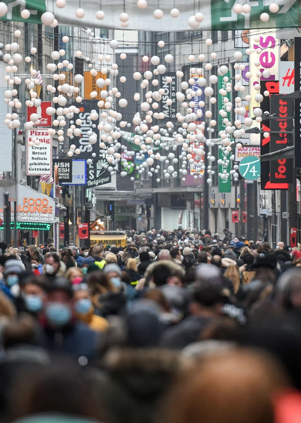 Shoppers in the streets of Cologne in western Germany last month. The German Chamber of Commerce and Industry said the unfilled positions have resulted in a loss of 100 billion euros (S$143 billion) in potential value creation. 