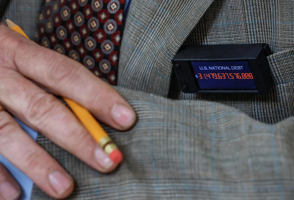 US Representative Thomas Massie wears a pin displaying the amount of the US national debt during a House Committee on Rules hearing about whether to raise the United States' debt ceiling and avoid a catastrophic default, at the US Capitol in Washington, May 30, 2023. 