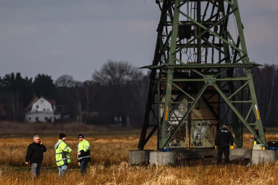 Police investigators inspect a damaged high-voltage pylon near the Tesla Gigafactory in Gruenheide. Local media published a letter purportedly from a far-left activist organisation called the Volcano Group that claimed responsibility for the incident, in a 2,500-word attack on Tesla and its billionaire CEO Musk.