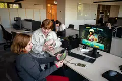 Inha Kushnir, left, and Nastya Dahno working at the headquartes of the game maker Nordcurrent in Vilnius, Lithuania, on May 23, 2022. They were among the employees in Ukraine that were evacuated by the company as Russia invaded. 