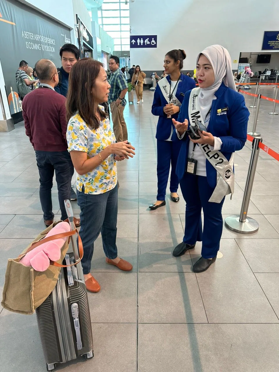 Malaysia Airports' staff helping  MYAirline passengers who were stranded in Kuala Lumpur International Airport 2 on Thursday.