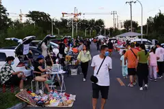 Car boot fair in Beijing. Hospitality, tourism and after-school tutoring have been particularly hard hit. 