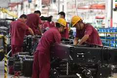 Employees work on an assembly line producing trucks at a factory in Fuyang in China's eastern Anhui province. China’s official manufacturing survey indicated activity contracted last month, raising fears that the economy’s recovery from widespread lockdowns in the Spring will be slower and bumpier than expected.