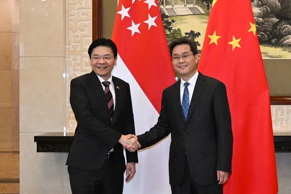 Singapore's Deputy Prime Minister Lawrence Wong (left) with Chinese Finance Minister Lan Fo'an at the Diaoyutai State Guesthouse in Beijing on Dec 8. It was the first time that both were meeting in their capacities as finance ministers.