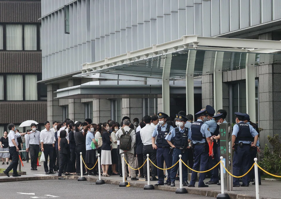 Staff members stand outside the Nara District Court after temporarily evacuating from the building after a suspicious object was delivered during the pre-trial hearing for Tetsuya Yamagami, the man accused of killing Japan's former prime minister Shinzo Abe, in Nara on June 12, 2023. 