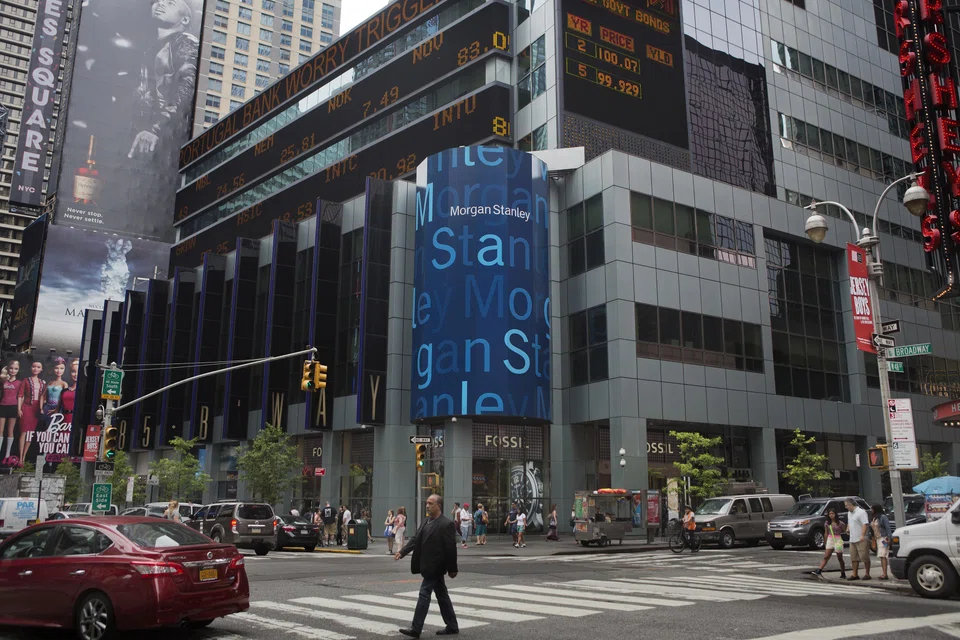 Pedestrians walk past Morgan Stanley headquarters in New York, U.S., on Thursday, July 10, 2014. Morgan Stanley is scheduled to release earnings on Thursday, July 17.   BLOOMBERG