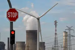 A wind turbine is seen in front of a coal-fired power plant operated by German energy supplier RWE in Niederaussem, Germany. Energy think tank Ember said renewable energy sources prevented a possible 4 per cent increase in power generation from polluting fossil fuels.