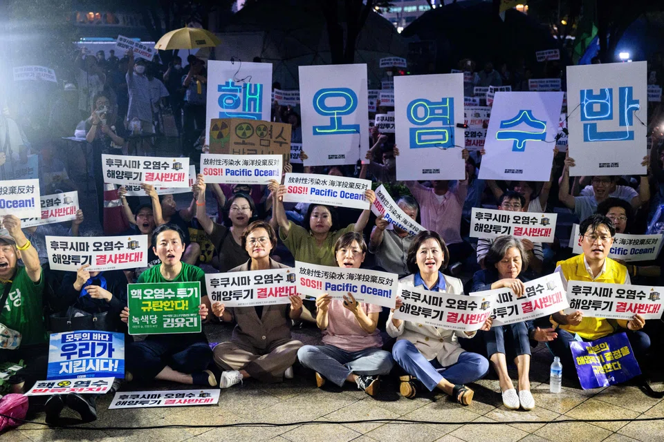 Activists hold placards that read "SOS!! Pacific Ocean!" in protest against the planned release of wastewater from Japan's stricken Fukushima nuclear plant into the Pacific ocean, Seoul, South Korea, Aug 22, 2023.