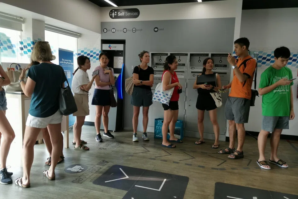 A queue for Coldplay concert tickets at the SingPost outlet in June.