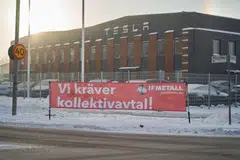 A banner reading "We demand a collective agreement" outside the Tesla service centre in Segeltorp, Sweden, on Dec 5. The labour row has spread to Denmark and Norway, where unions have warned they will block shipments of Tesla cars.