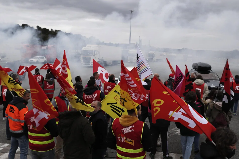 Strikers blocking a motorway on Thursday; polls show that a majority of voters oppose President Emmanuel Macron’s plan to delay the state pension age by two years to 64.