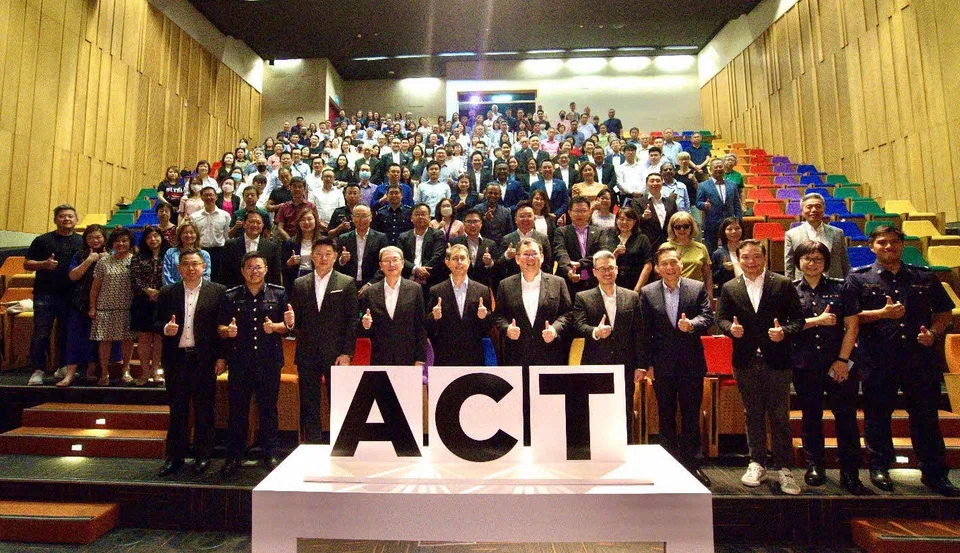 Scams are increasingly sophisticated, and the property market is not immune to them, says Minister of State for Home Affairs and National Development Faishal Ibrahim (front row, fifth from left).