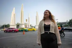 Former protest leader Panusaya “Rung” Sithijirawattanakul posing for a photo in front of the Democracy Monument in Bangkok, Thailand, April 6, 2023.
