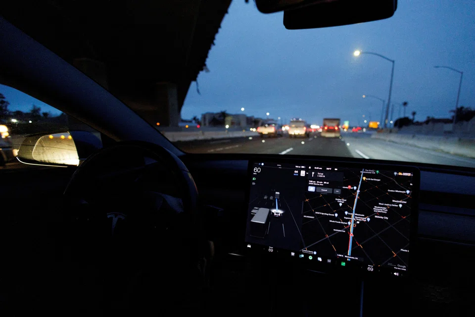 A Tesla Model 3 vehicle drives on autopilot along the 405 highway in Westminster, California, US, March 16, 2022. 