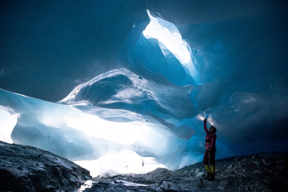 Glaciologist Andrea Fischer from the Austrian Academy of Sciences explores a natural glacier cavity of the Jamtalferner glacier near Galtuer, Austria. Giant ice caves have appeared in glaciers, accelerating the melting process  as warmer air rushes through the ice mass until it collapses.  