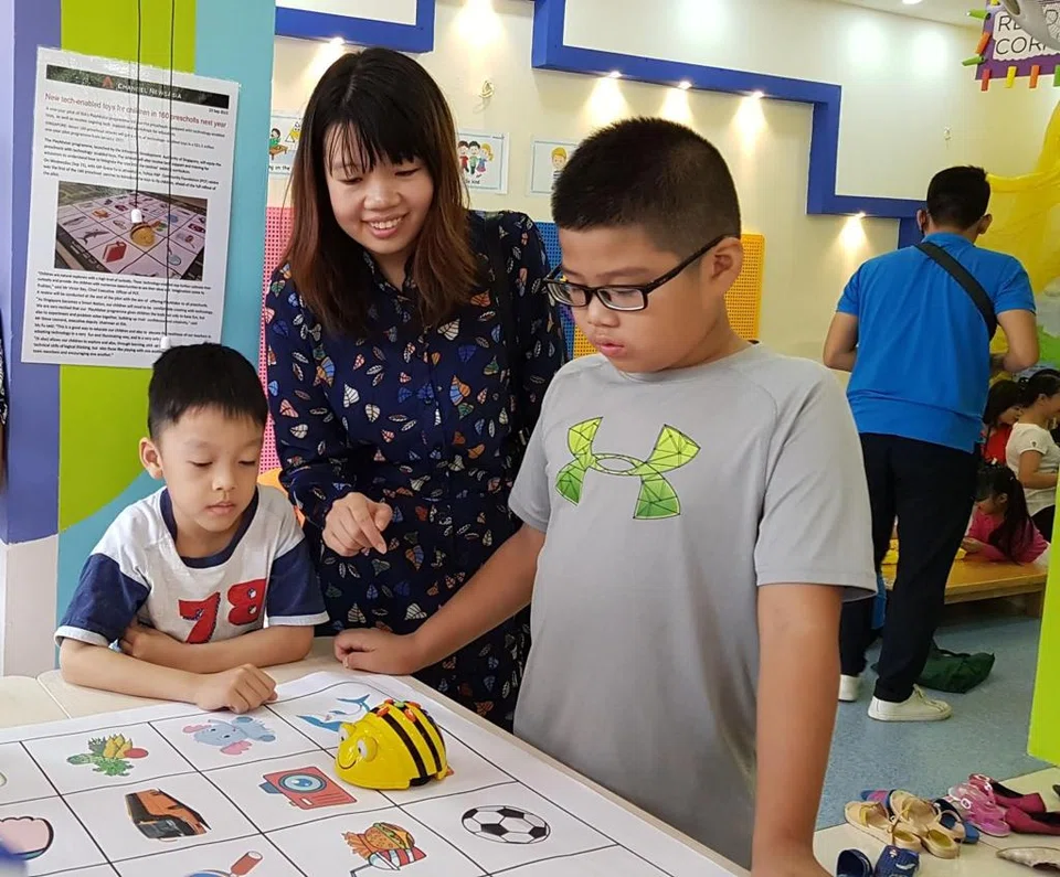 Preschool Market chief executive Cheong Sufen (in black) conducts a robotics toy demonstration. The consultancy also works with charity-based or non-profit preschools, as well as preschools in developing countries.
