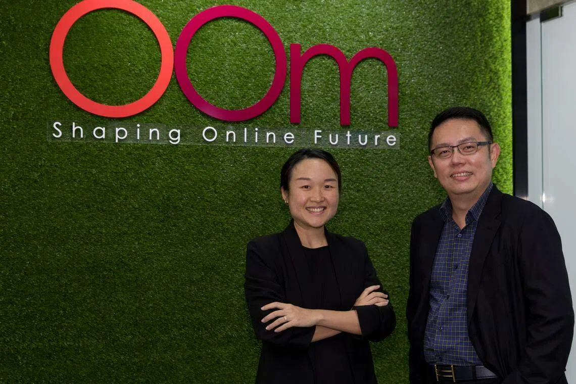 Oom chief executive officer Cheow Yu Yuan (right) says that career conversion programmes have enabled the company to hire mid-career switchers such as Ng Jia Min, who is now assistant team lead of search engine optimisation.