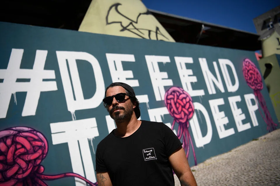 Portuguese visual artist Goncalo Mar  next to his work "Mural For The Deep Ocean" in Lisbon on Jul 1, when a major United Nations conference was held to discuss the restoration of the world's oceans. A flurry of promises were made to expand marine protected areas, ban deep-sea mining, and combat illegal fishing. 