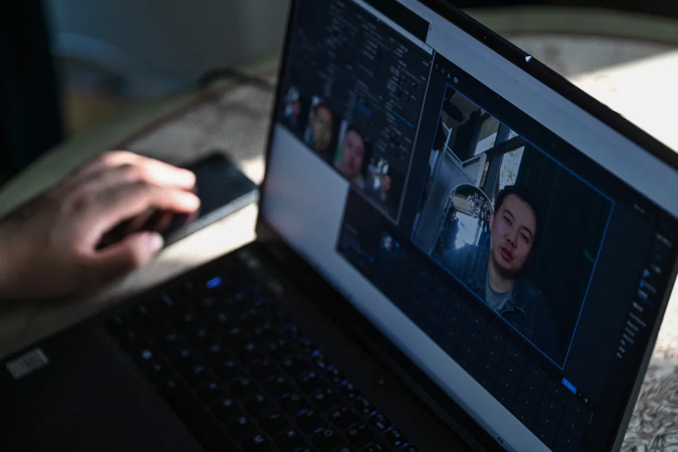 Zhang Zewei, founder of AI firm Super Brain which specialises in digital replicas of the dead, creates a demonstration video using artificial intelligence on his laptop in Jiangyin, China's eastern Jiangsu province, Nov 8, 2023. 