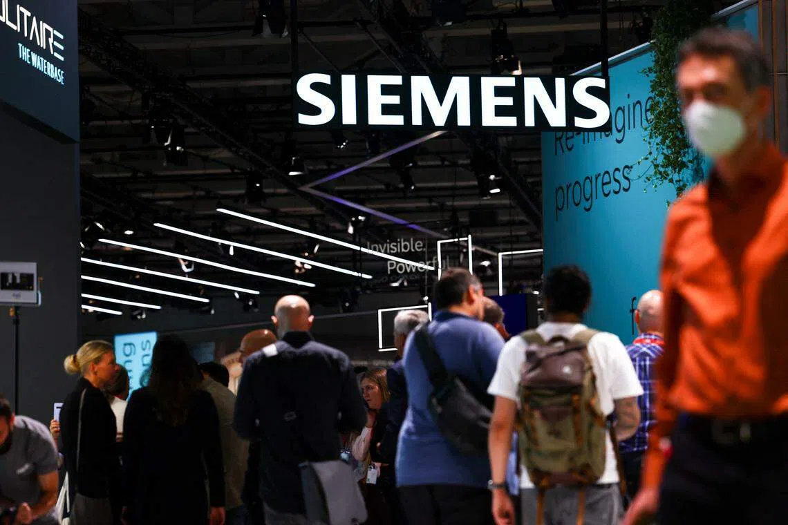 Visitors walk under a Siemens sign at the international consumer technology fair IFA in Berlin, Germany September 2, 2022. REUTERS/Lisi Niesner
