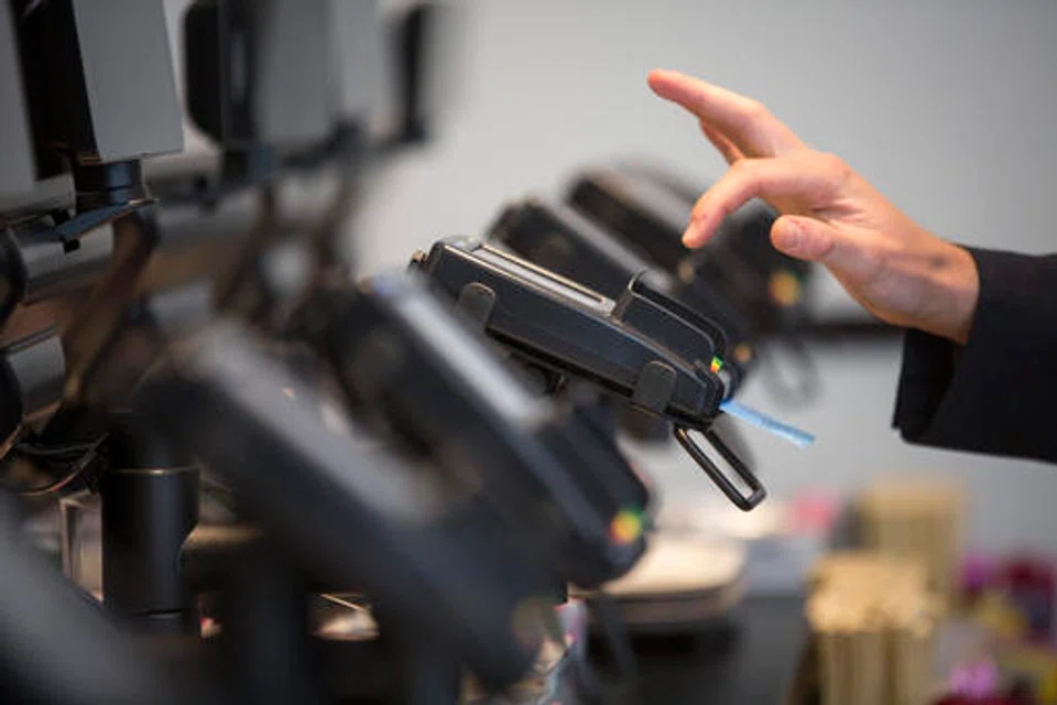 A customer making a chip and pin payment via a Verifone Systems Inc credit card payment device at a restaurant in London.  