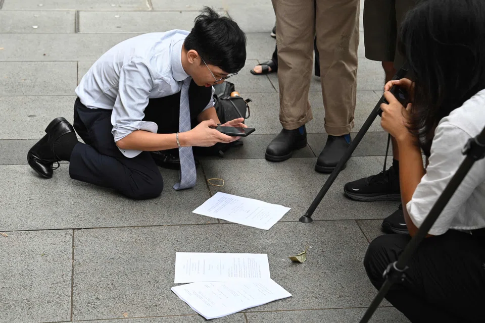 A journalist photographs the latest ruling on same-sex marriage decided by the Court of Final Appeal in Hong Kong. The court ruled in favour of same-sex partnerships including civil unions, though it stopped short of granting full marriage rights, in a partial win for the city's LGBTQ+ community. 