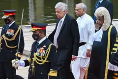 Sri Lanka's President Ranil Wickremesinghe (C), Prime Minister Dinesh Gunawardena and  Parliament Speaker Mahinda Yapa Abeywardena leave the Sri Lankan Parliament after opening a new session in Colombo on August 3, 2022. 