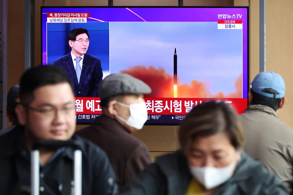 People watch a TV broadcasting a news report on North Korea firing a ballistic missile of intermediate range or longer, at a railway station in Seoul, South Korea, April 13, 2023.   