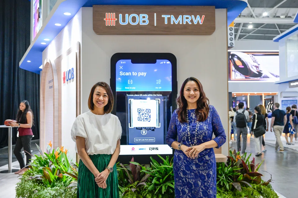 From left: Choo Wan Sim, head of UOB TMRW Digital (Singapore) and Jacquelyn Tan, head of group personal financial services, showcasing the "scan to pay" feature on UOB TMRW App. UOB customers in Singapore can now use the function to make payments in Malaysia, Thailand and Indonesia. 