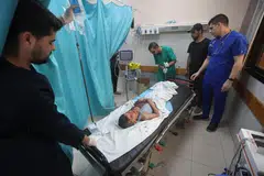 A Palestinian child wounded in Israeli strikes at a hospital in the southern Gaza Strip. The WHO warned that if aid is not allowed into the besieged territory, doctors will have to “prepare death certificates for their patients”.