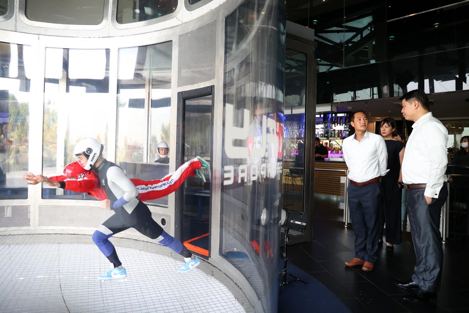 The  Industry Digital Plan’s introduction is timely as the tourism sector continues to recover from the pandemic, says Senior Minister of State for Communications and Information Tan Kiat How (second from right). With him is iFly Singapore CEO Lawrence Koh.