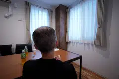 A man, who said he was jailed for two years for scamming others, speaks during an AFP interview on condition of anonymity at temporary housing for ex-prisoners in Tokyo, Japan, August 27, 2023. 